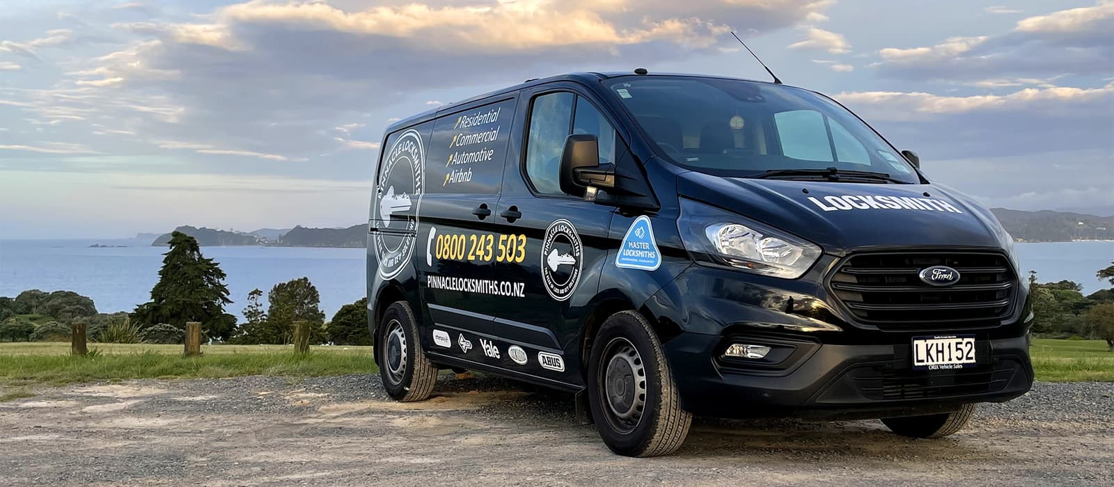 The Pinnacle Locksmiths mobile van parked above the coast at dusk in Northland