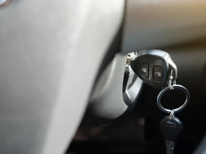 A transponder car key being cut and programmed in the mobile locksmith van
